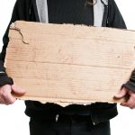 Homeless Man Holding Cardboard Sign